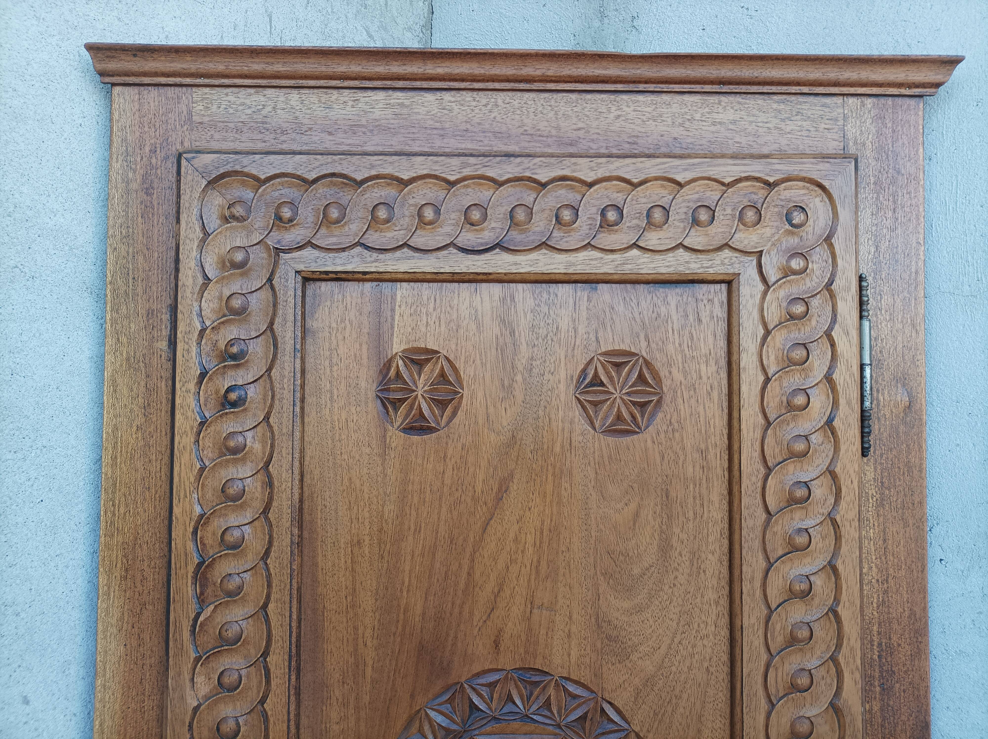 Corner cabinet in carved walnut, Savoyard style.