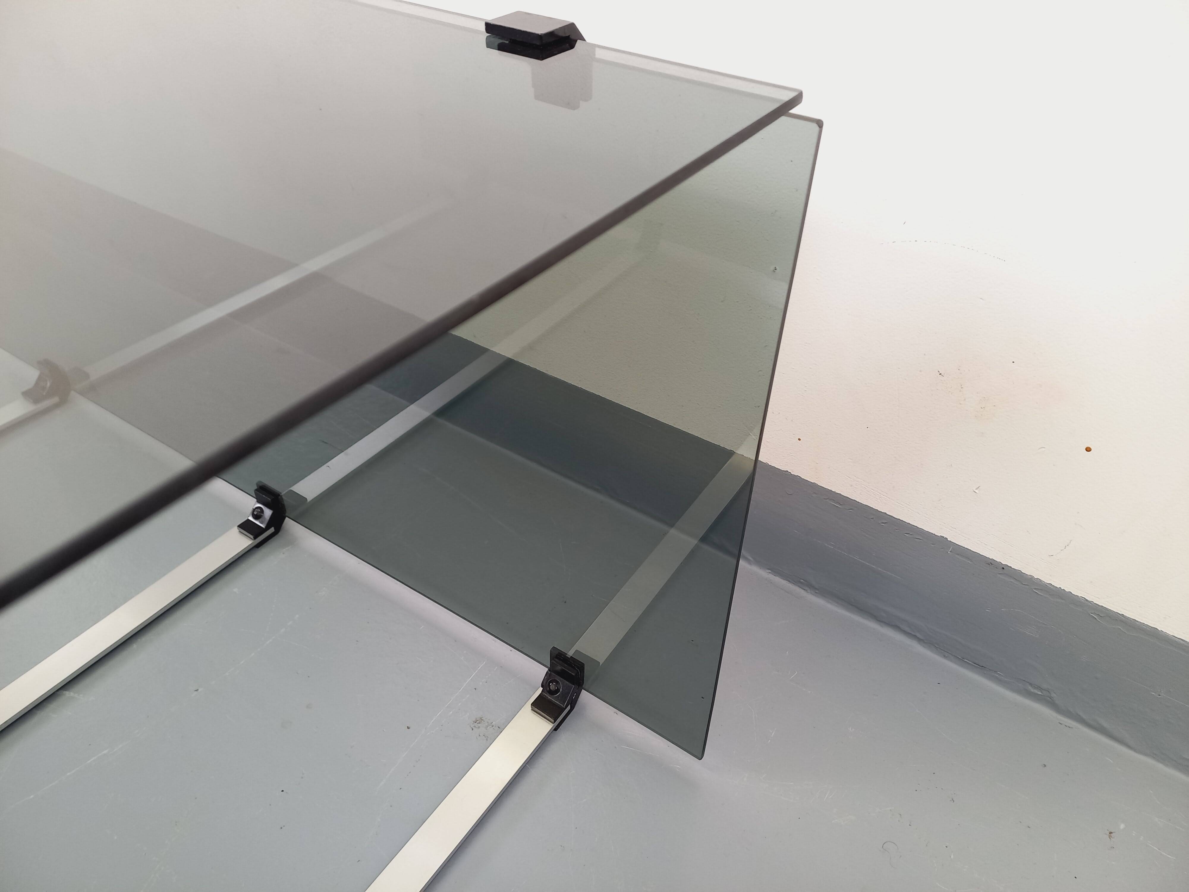 Vintage coffee table in smoked glass, black metal and cast aluminum