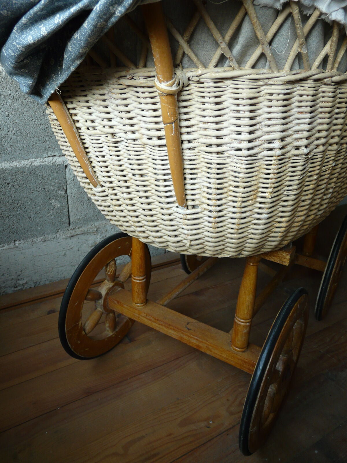 Old wooden cradle and wicker on wheels