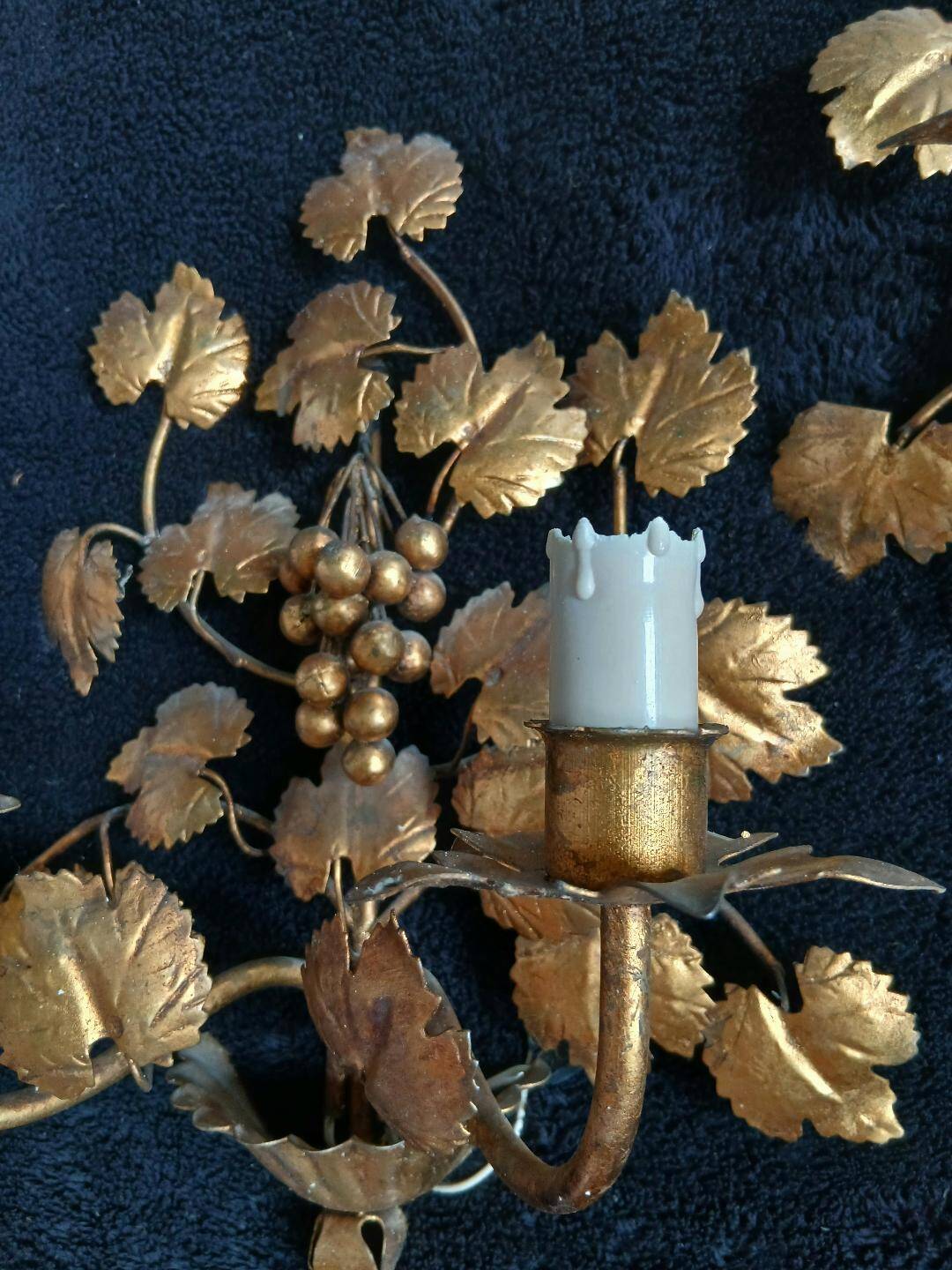 Stunning vintage wall lights in gilded iron with vine and grape decor from Italy.