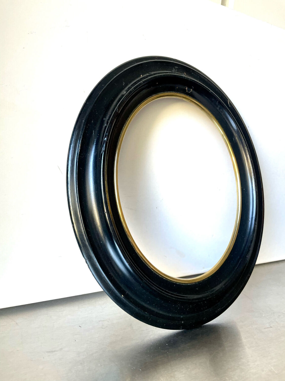 Black wooden oval frame