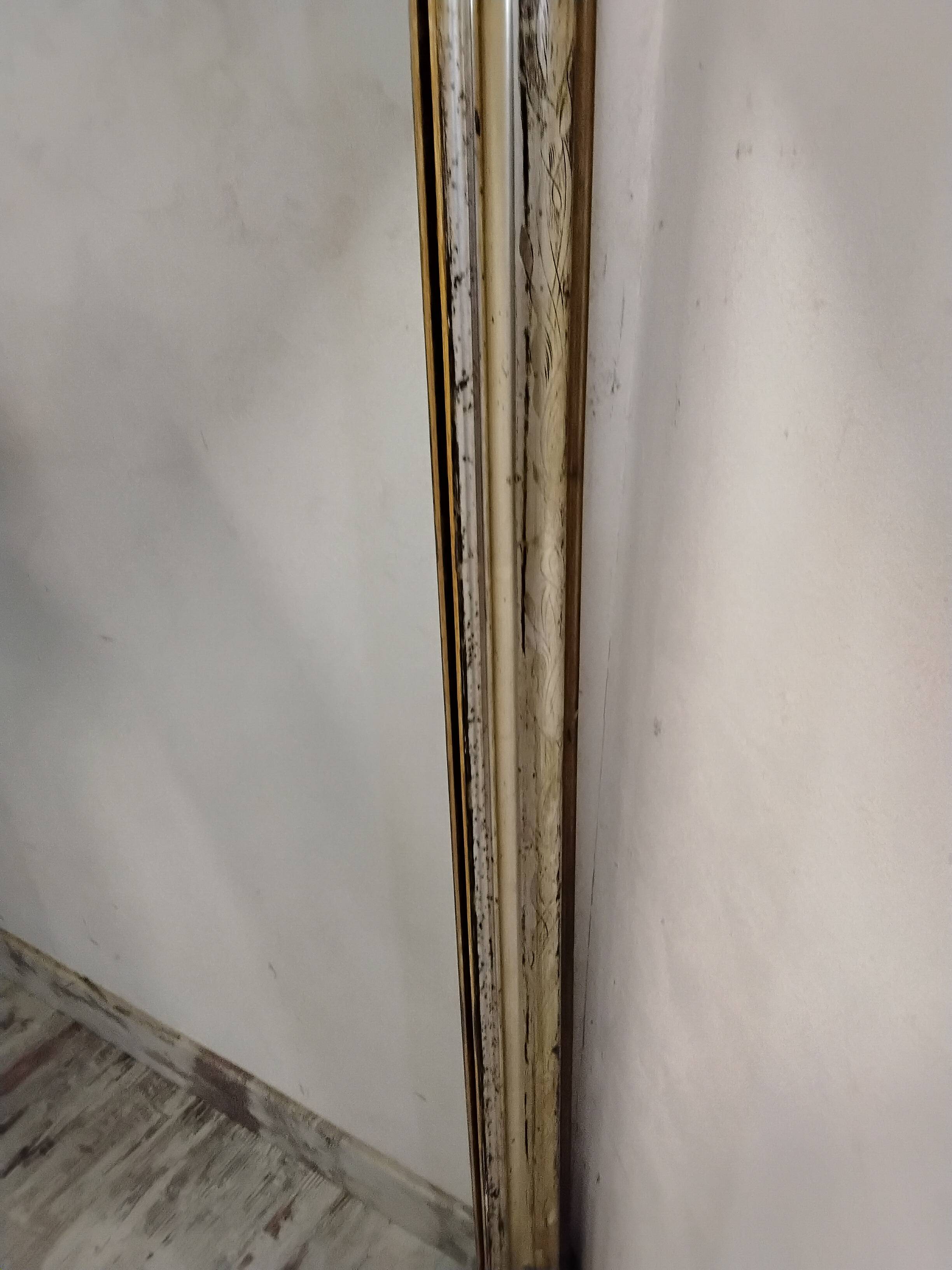 Antique mirror with a gilded frame and cherubs.
