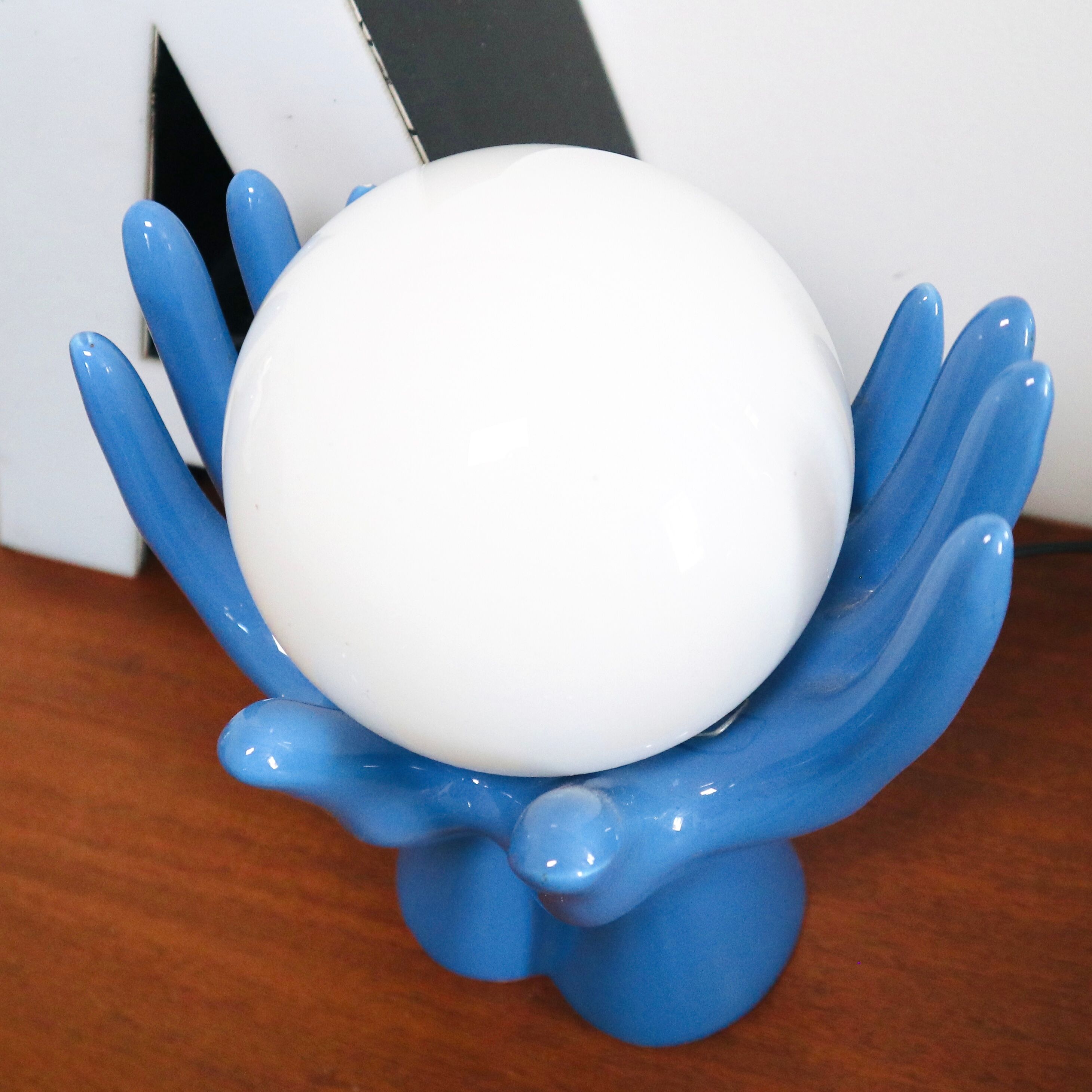 Ceramic lamp hands holding blue globe