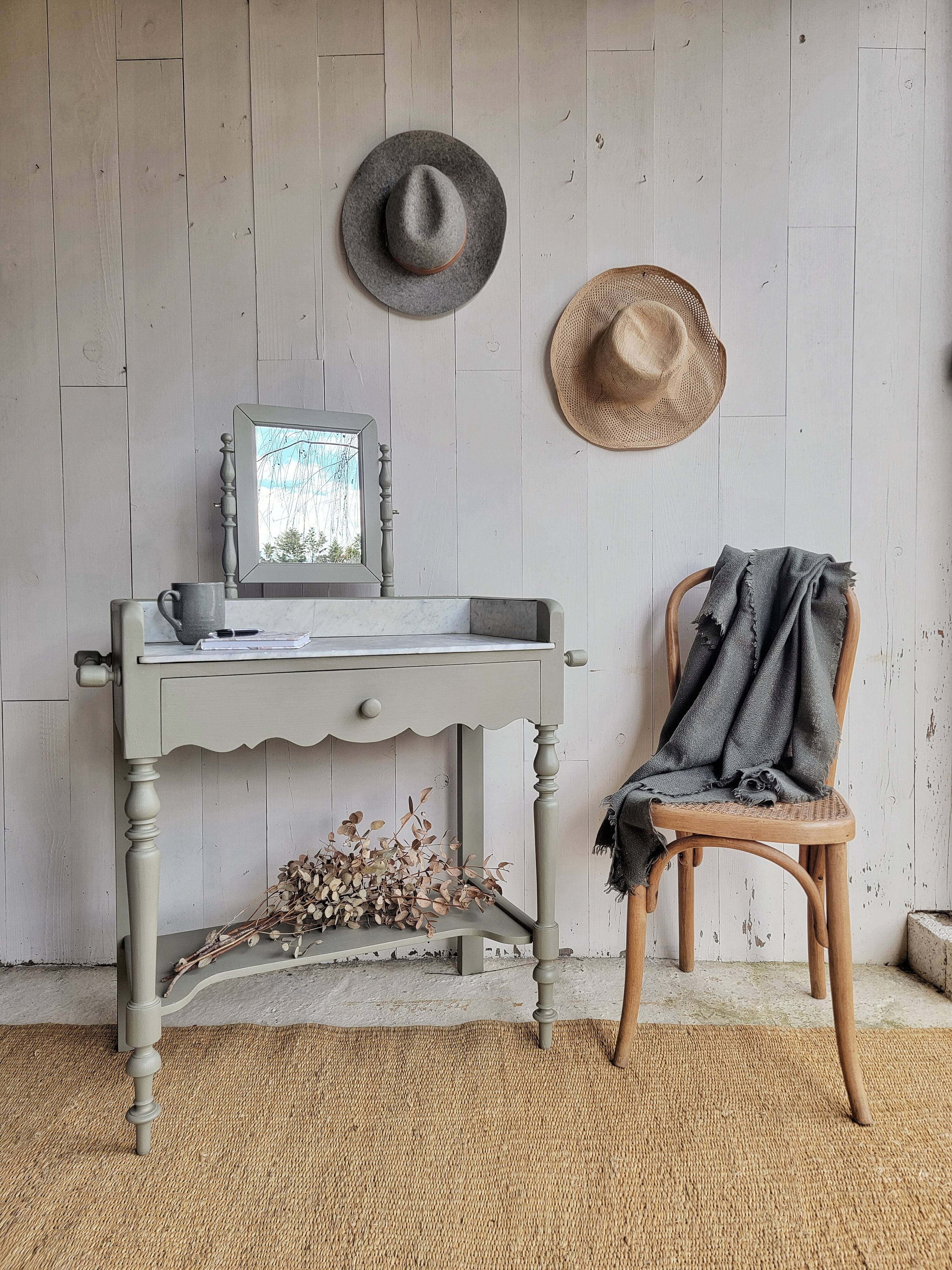 Antique wooden dressing table with marble top and mirror.