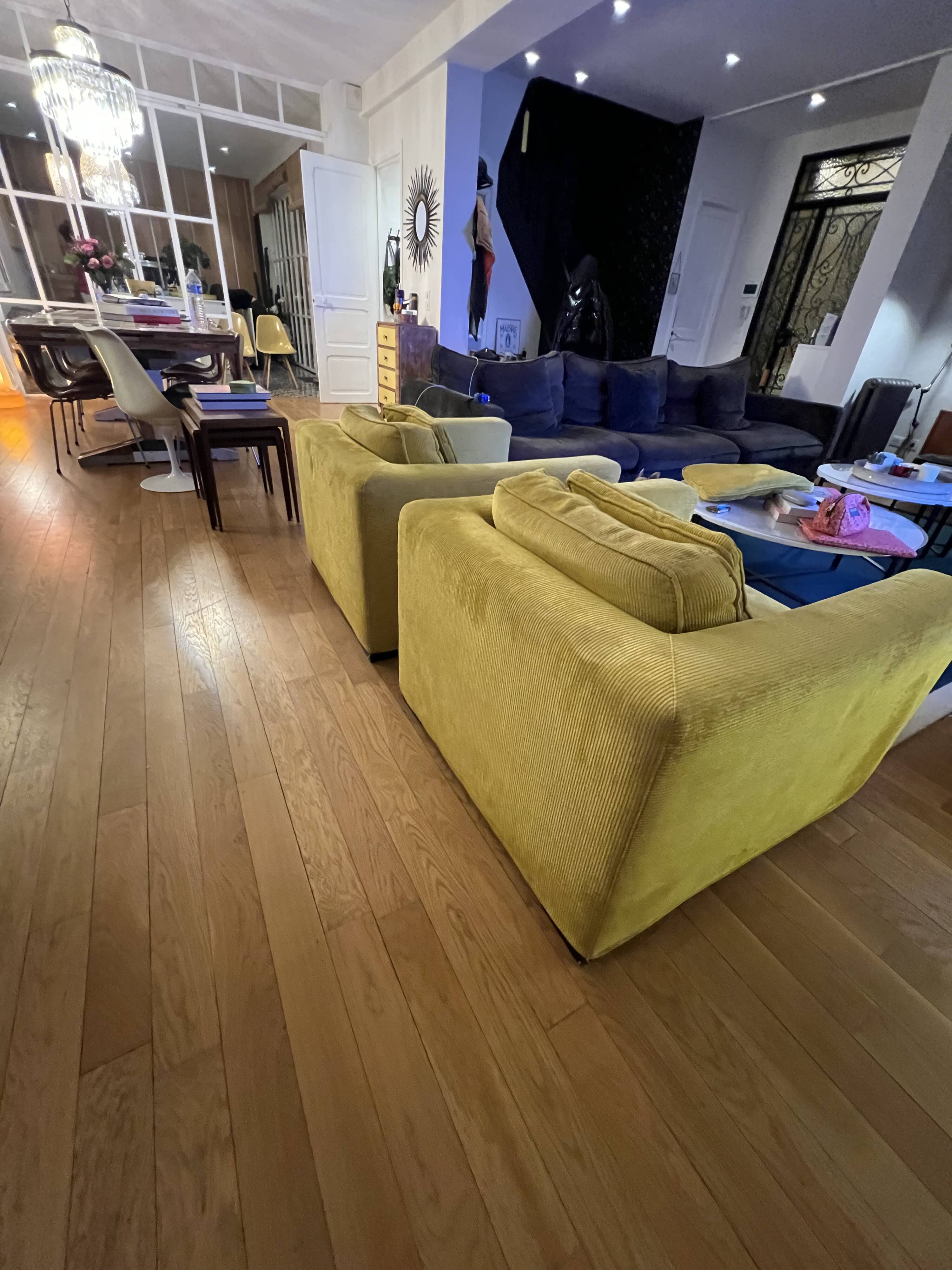 Two yellow Roche Bobois Longislande armchairs.