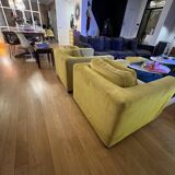 Two yellow Roche Bobois Longislande armchairs.