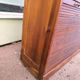 Vintage 1940s secretary desk with wooden curtains, storage, and shutters.