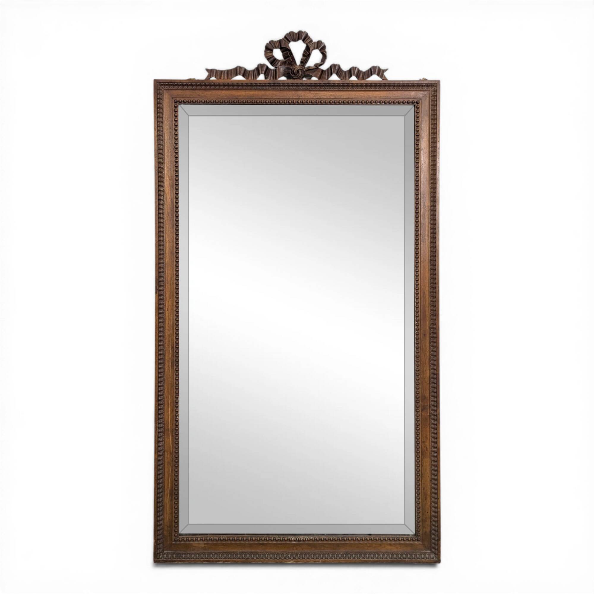 Louis XVI style mirror in carved walnut.