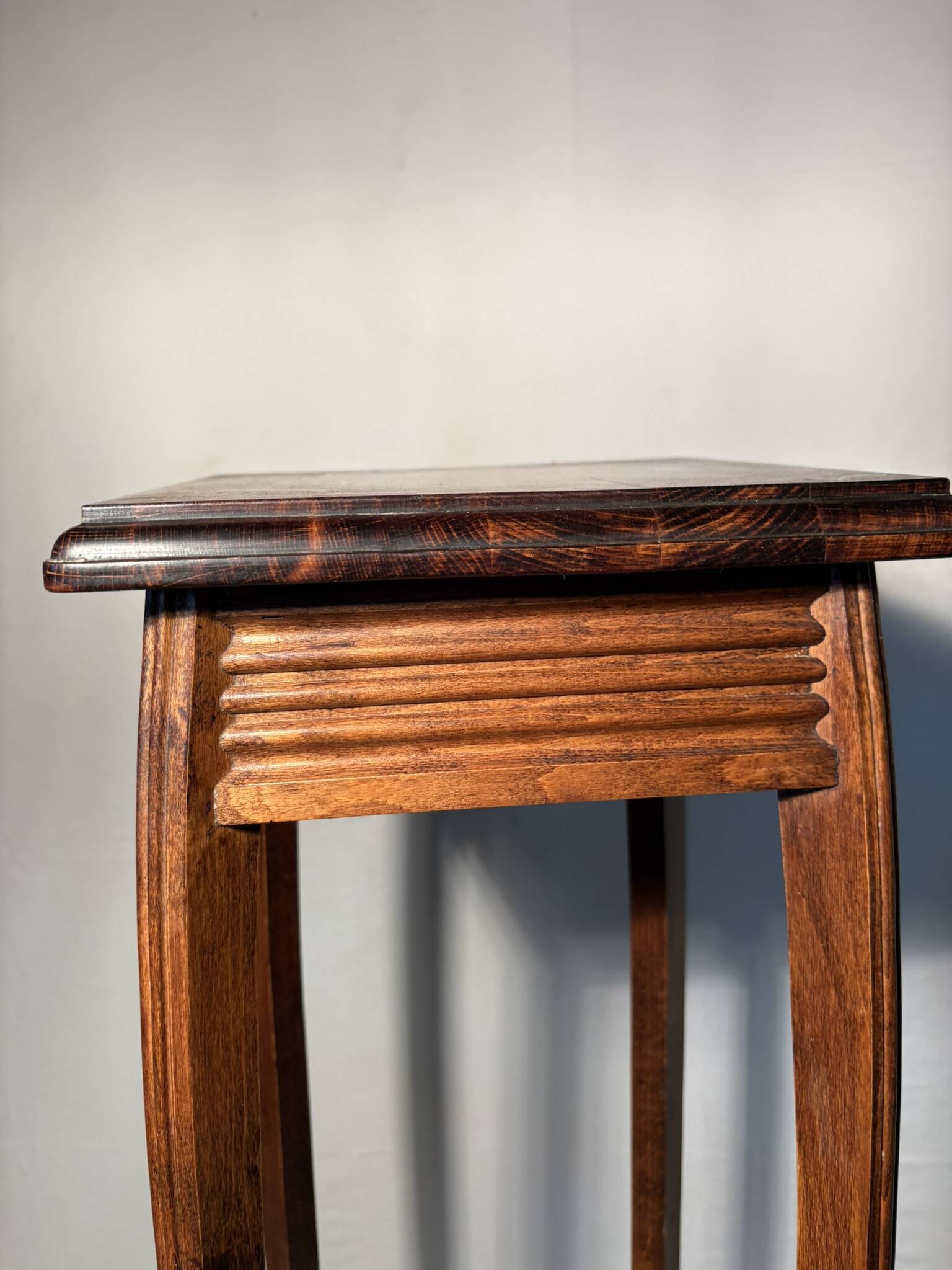 Vintage dark wood side table with curved base