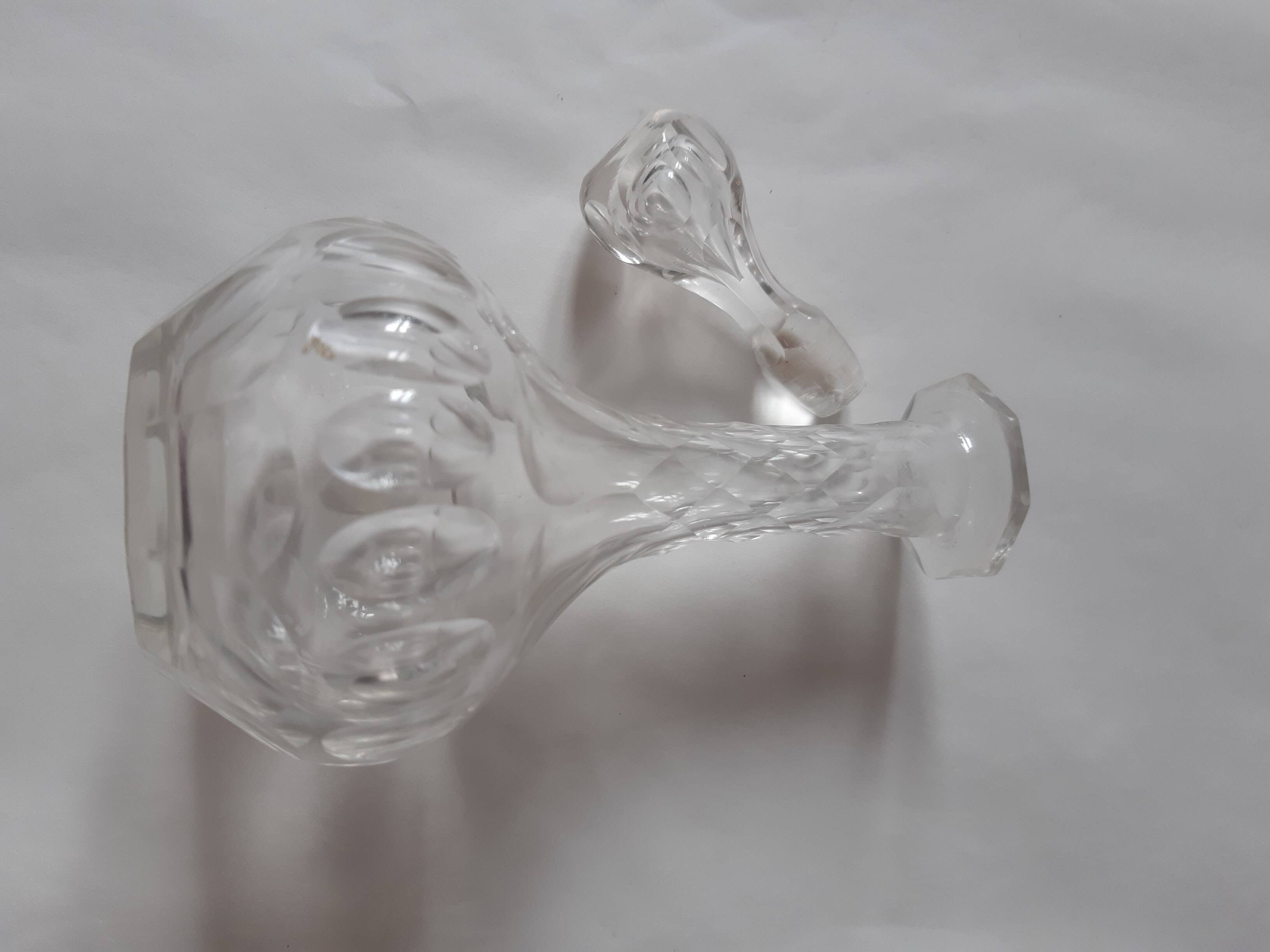 Cut crystal oil bottle with its crystal stopper.