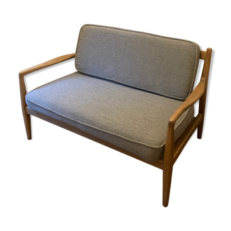 wooden bench with grey cushions