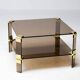 Hollywood Regency coffee table in brass and smoked glass, chic two-tier coffee table.