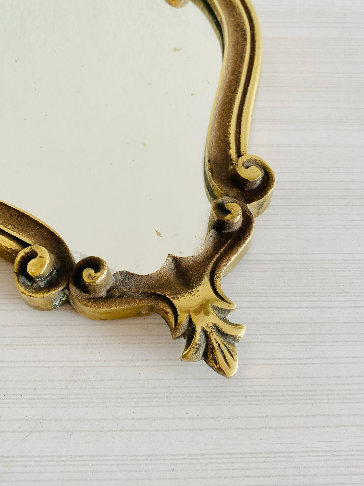 Small antique mirror in baroque style – gold frame in bronze or brass.