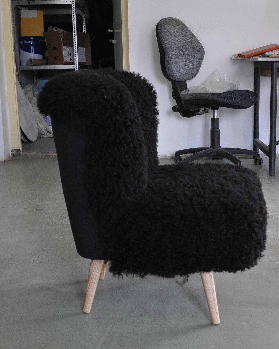 Mid-century black cocktail chair in lambskin, beech legs — 1960s