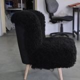 Mid-century black cocktail chair in lambskin, beech legs — 1960s
