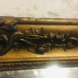 Old mirror with gilded leaves and flowers carved on top of it 1800s