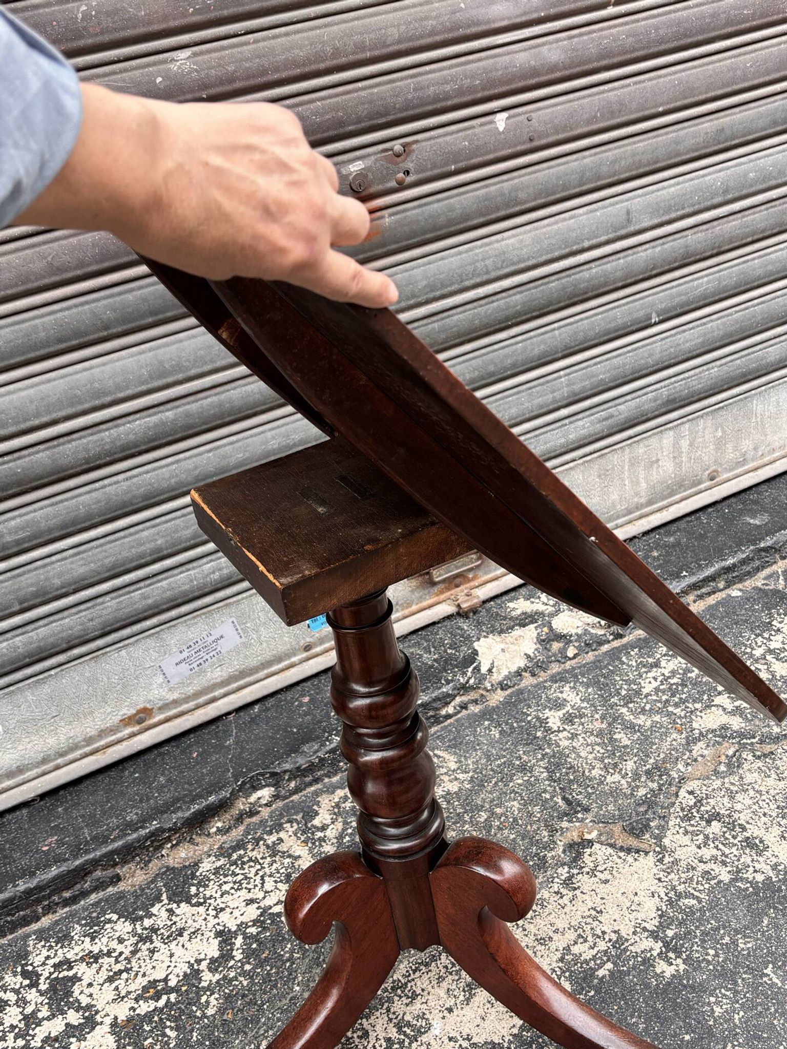 19th-century solid mahogany table with a tilting top and brass mechanism.