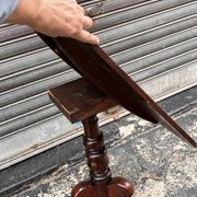 19th-century solid mahogany table with a tilting top and brass mechanism.
