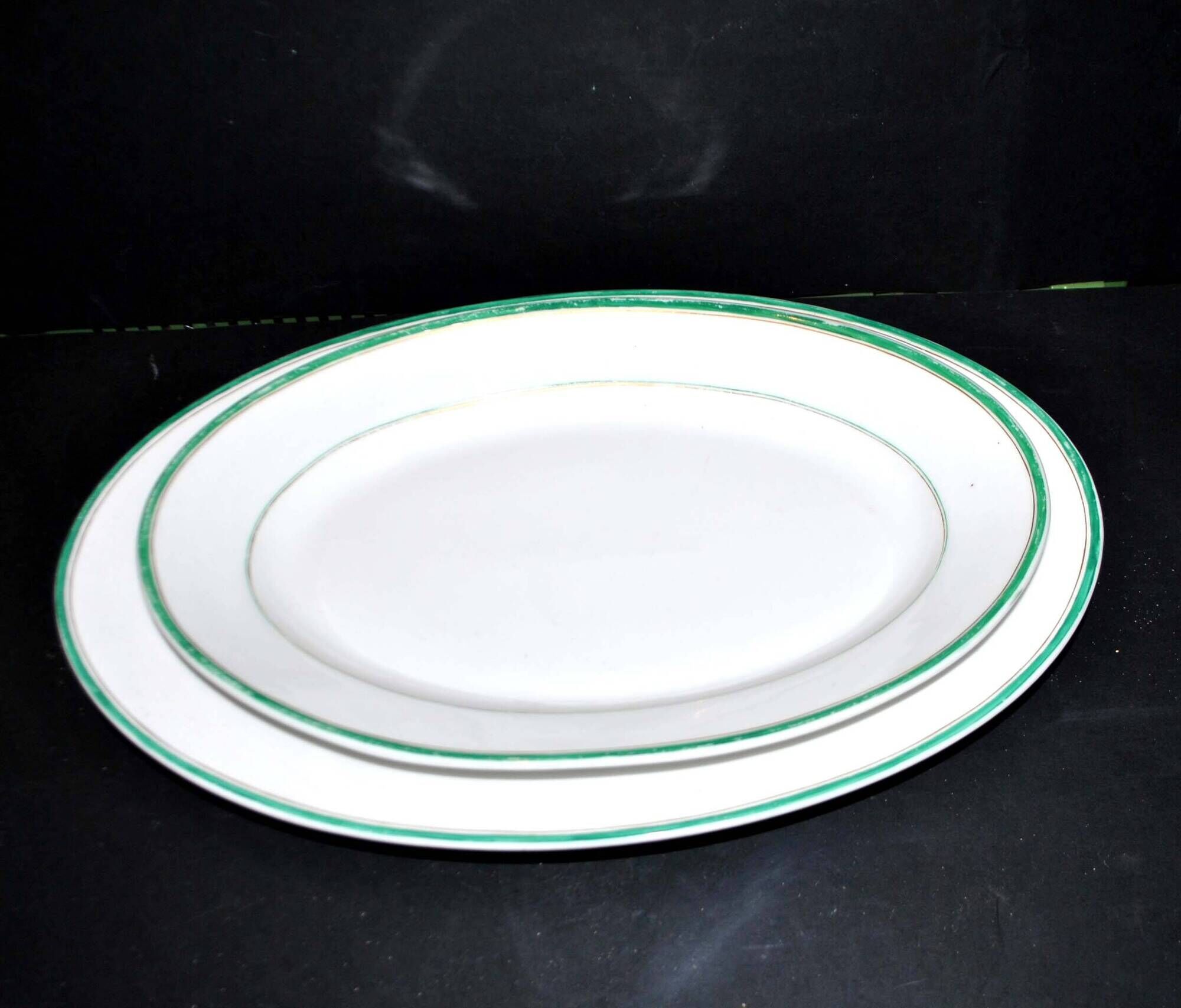 Limoges set of 2 old oval porcelain dishes with green and gold edging