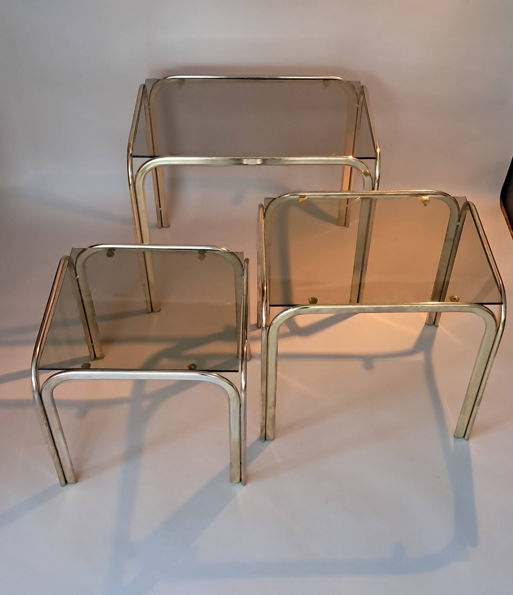 3 vintage golden nesting tables with smoked glass.