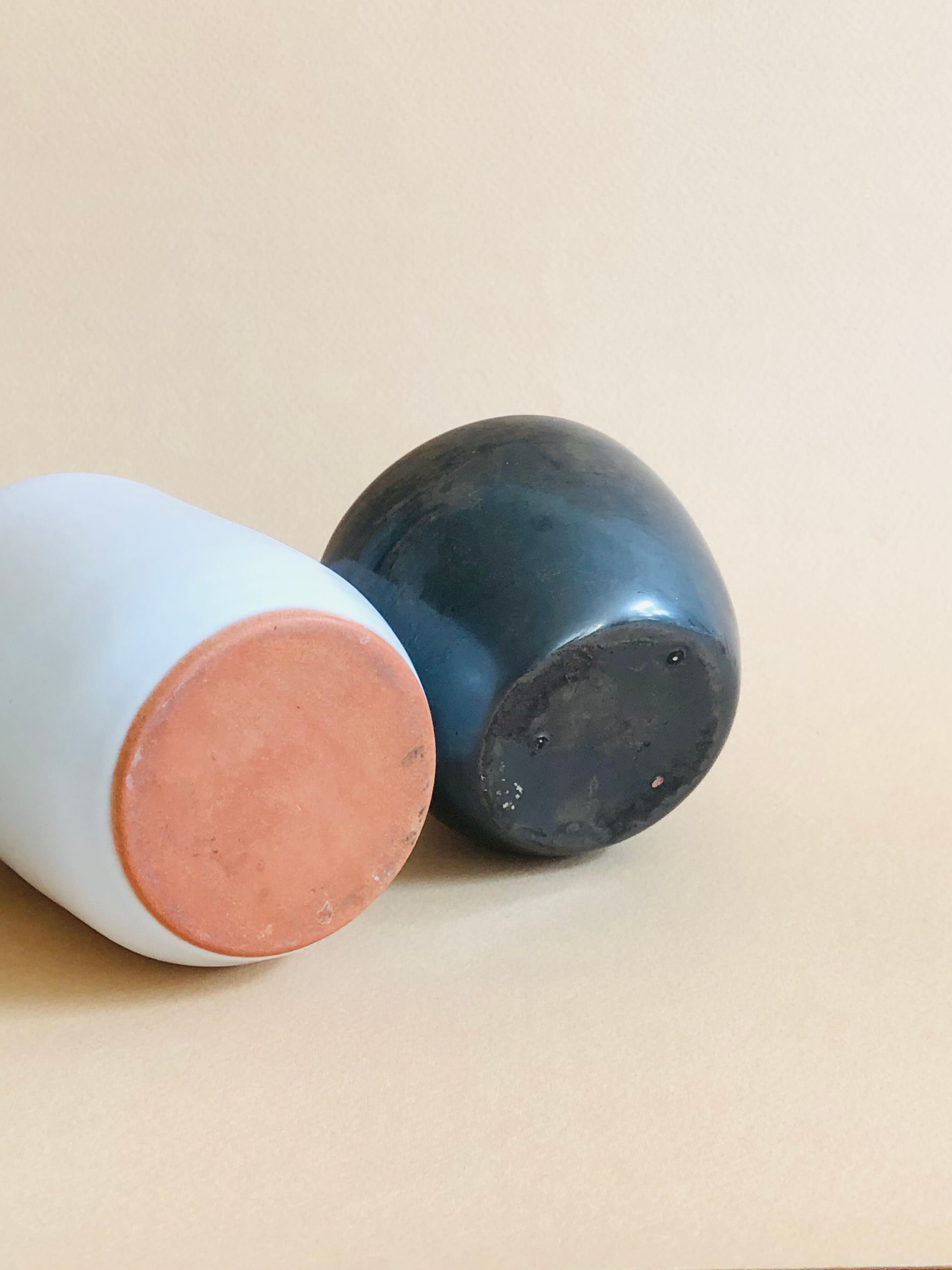 Duo of small black and white ceramic vases