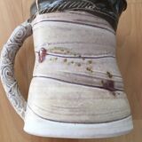 Signed ceramic pitcher. Glazed part. Worked cove