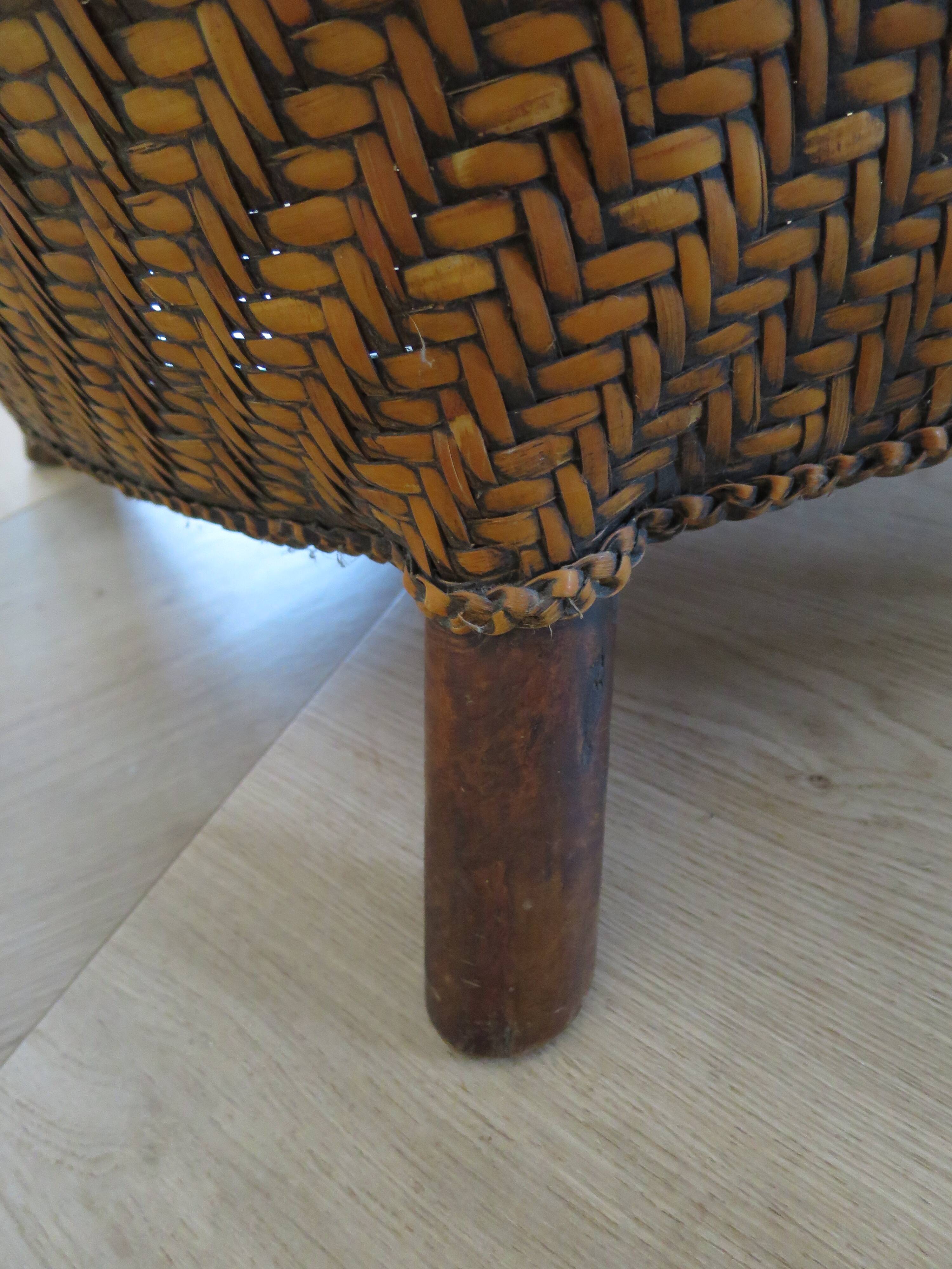 Colonial style armchair in woven rattan and exotic wood