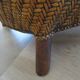 Colonial style armchair in woven rattan and exotic wood