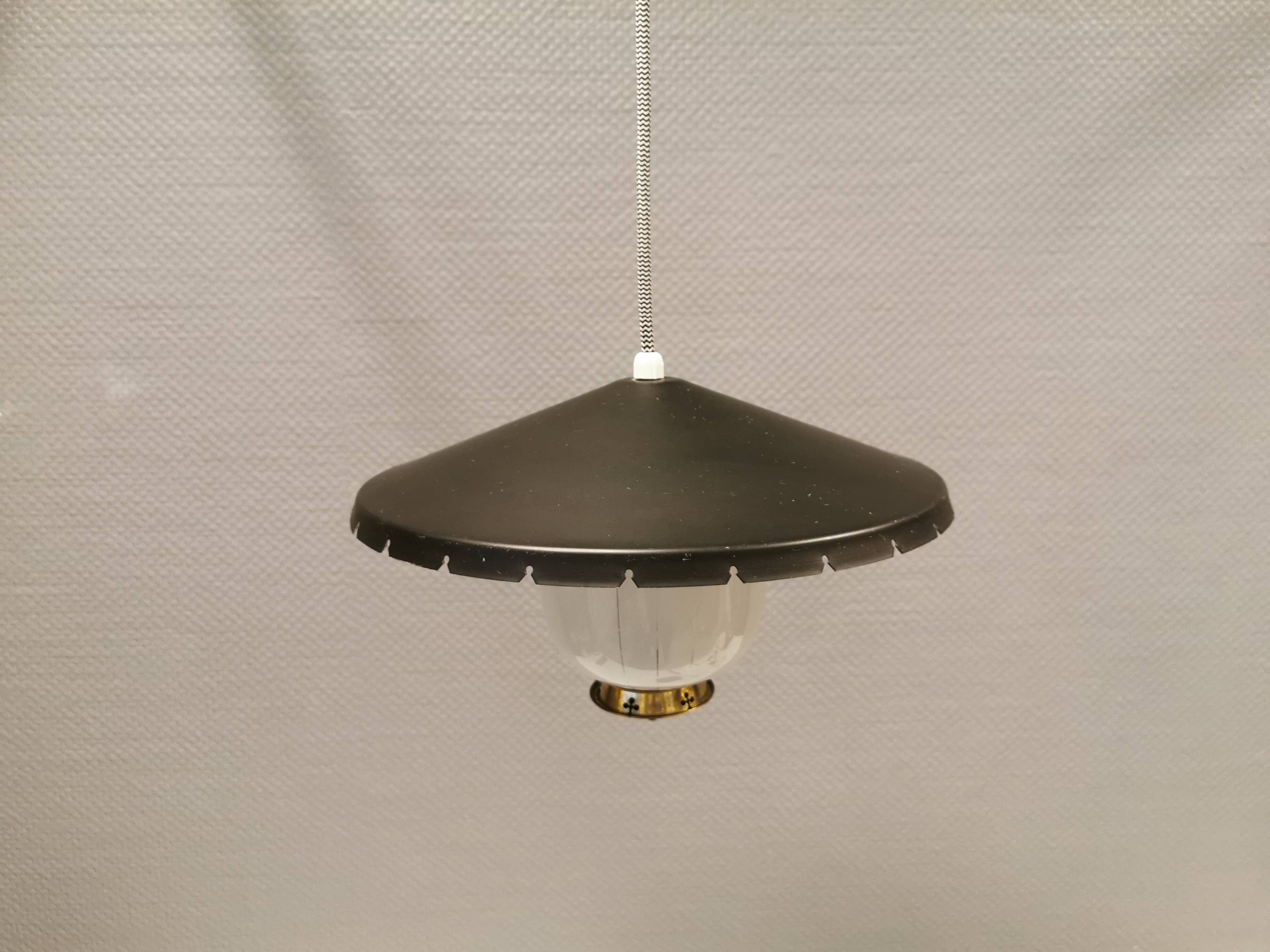 Hanging lamp in glass with black lacquered metal shade and brass base.