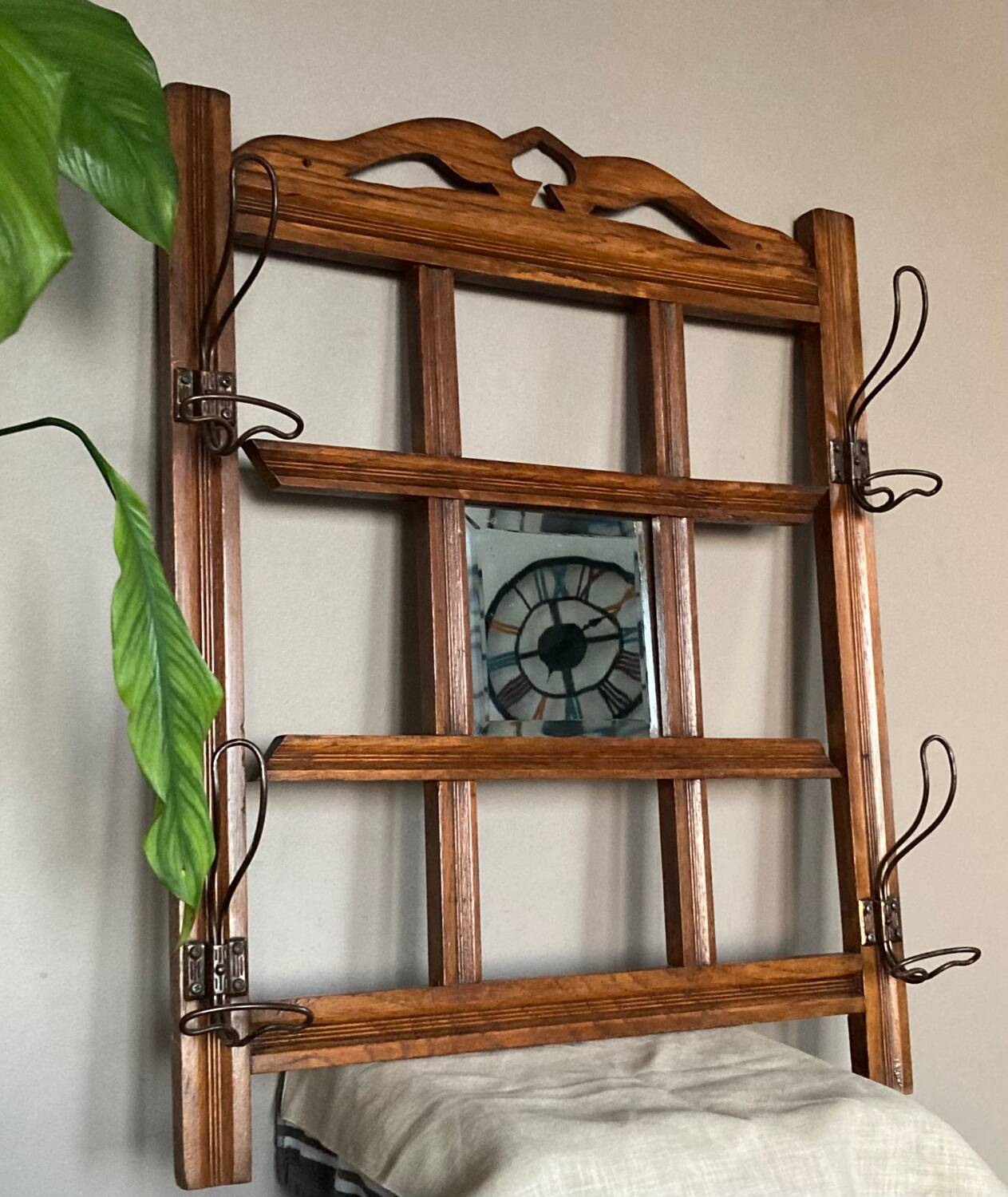 Art Deco wall-mounted coat rack in oak, early 20th century. Beveled central mirror