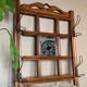 Art Deco wall-mounted coat rack in oak, early 20th century. Beveled central mirror