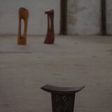 Sculptural African stool in hardwood, curved seat and architectural base, 1970s.
