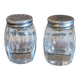 Antique salt and pepper shakers in crystal and silver metal.
