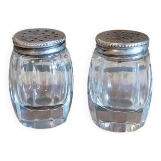 Antique salt and pepper shakers in crystal and silver metal.