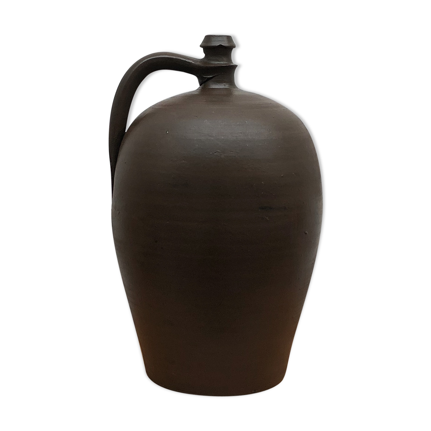 Ancient varnished sandstone jug