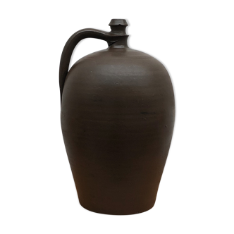 Ancient varnished sandstone jug