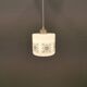 Scandinavian hanging lamp in white glass with inlayed black motifs.