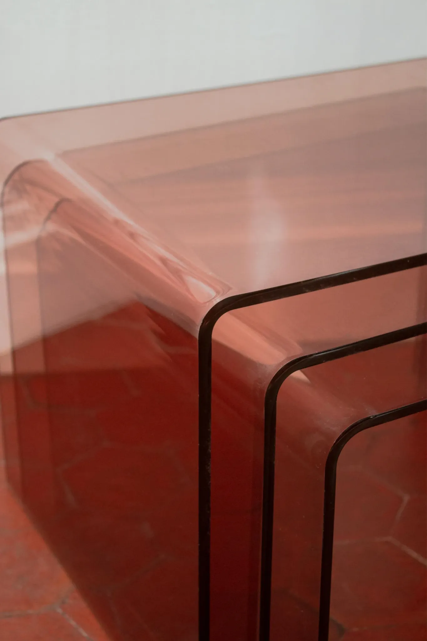 Vintage trio of nesting tables in smoked plexiglass by Michel Dumas, year