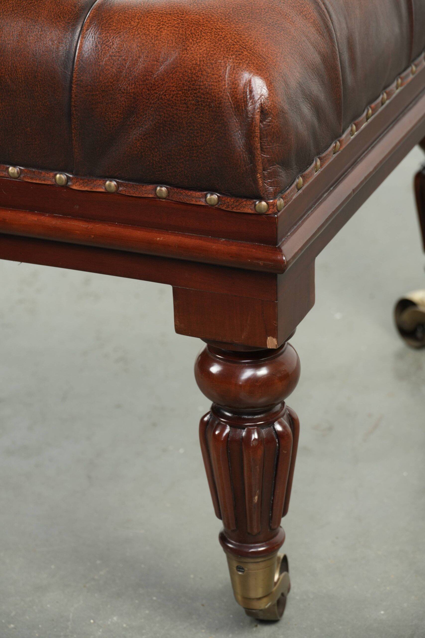 Brown cowhide Chesterfield ottoman in English style with ornate legs