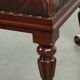 Brown cowhide Chesterfield ottoman in English style with ornate legs
