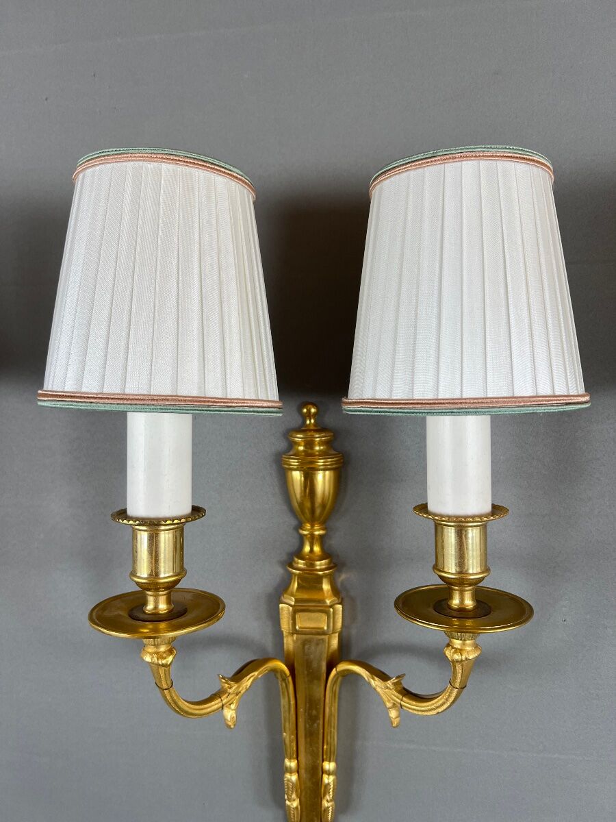 Set of three Louis XVI style wall sconces in gilded bronze, 20th century.