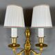 Set of three Louis XVI style wall sconces in gilded bronze, 20th century.