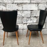 Pair of Baumann model Essor chairs in faux black leather, beech compass footing