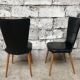 Pair of Baumann model Essor chairs in faux black leather, beech compass footing
