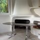 Dining table with stainless steel and smoked glass.