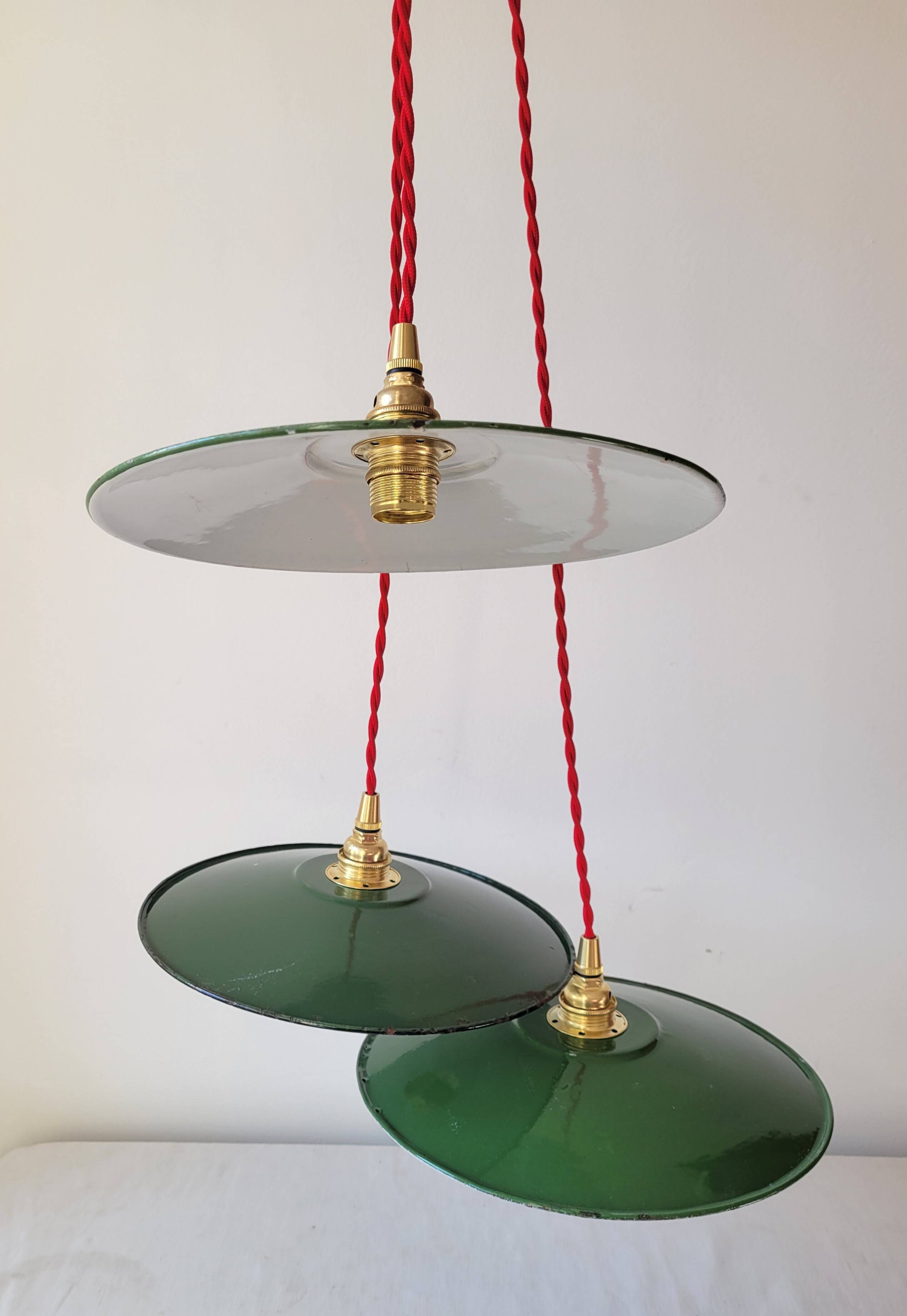 Trio of enameled sheet metal pendant lights