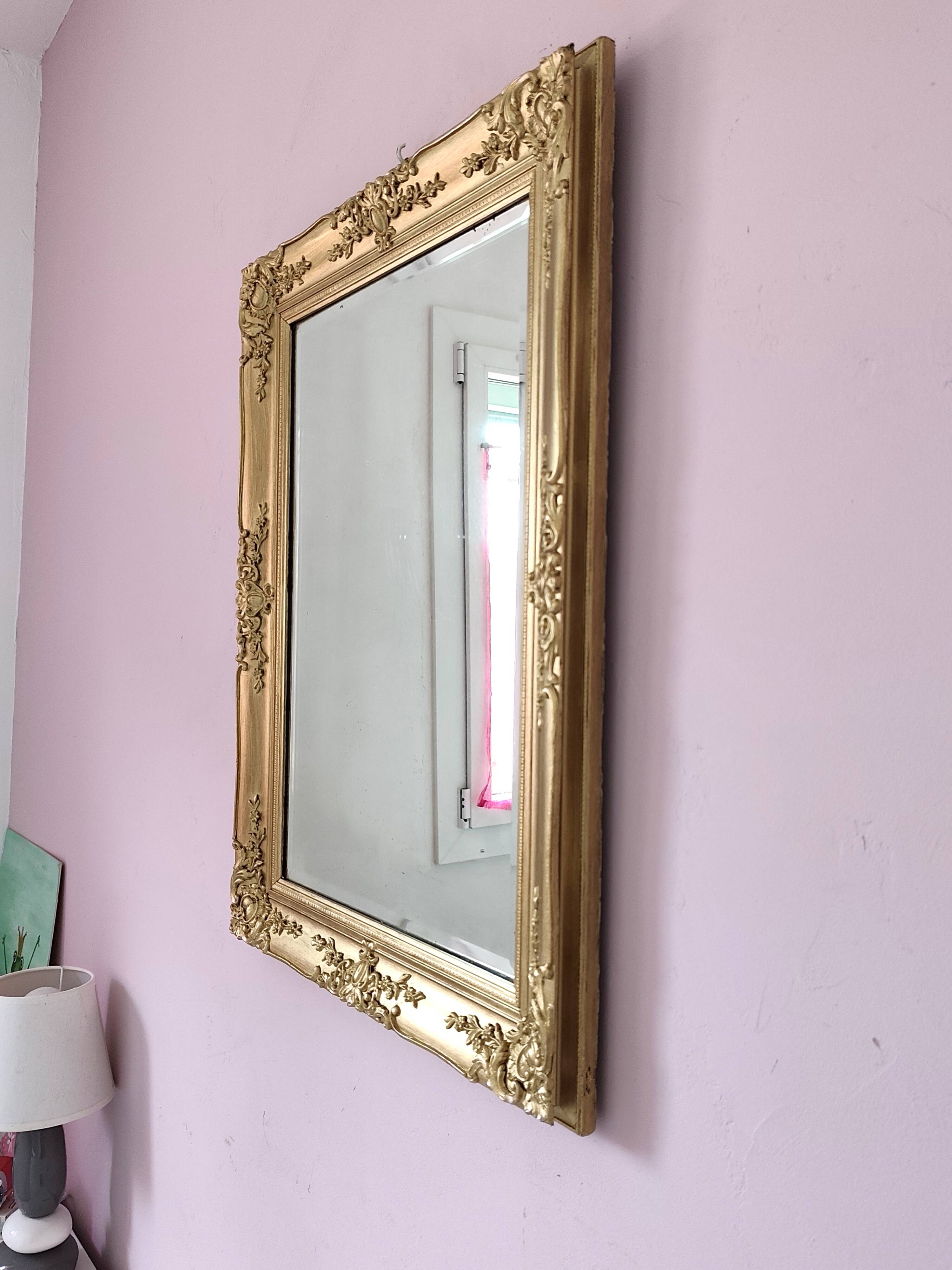 Richly carved antique gilded mirror