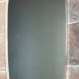 Vintage 1960s mirror in a freeform shape with a gold and red trim.