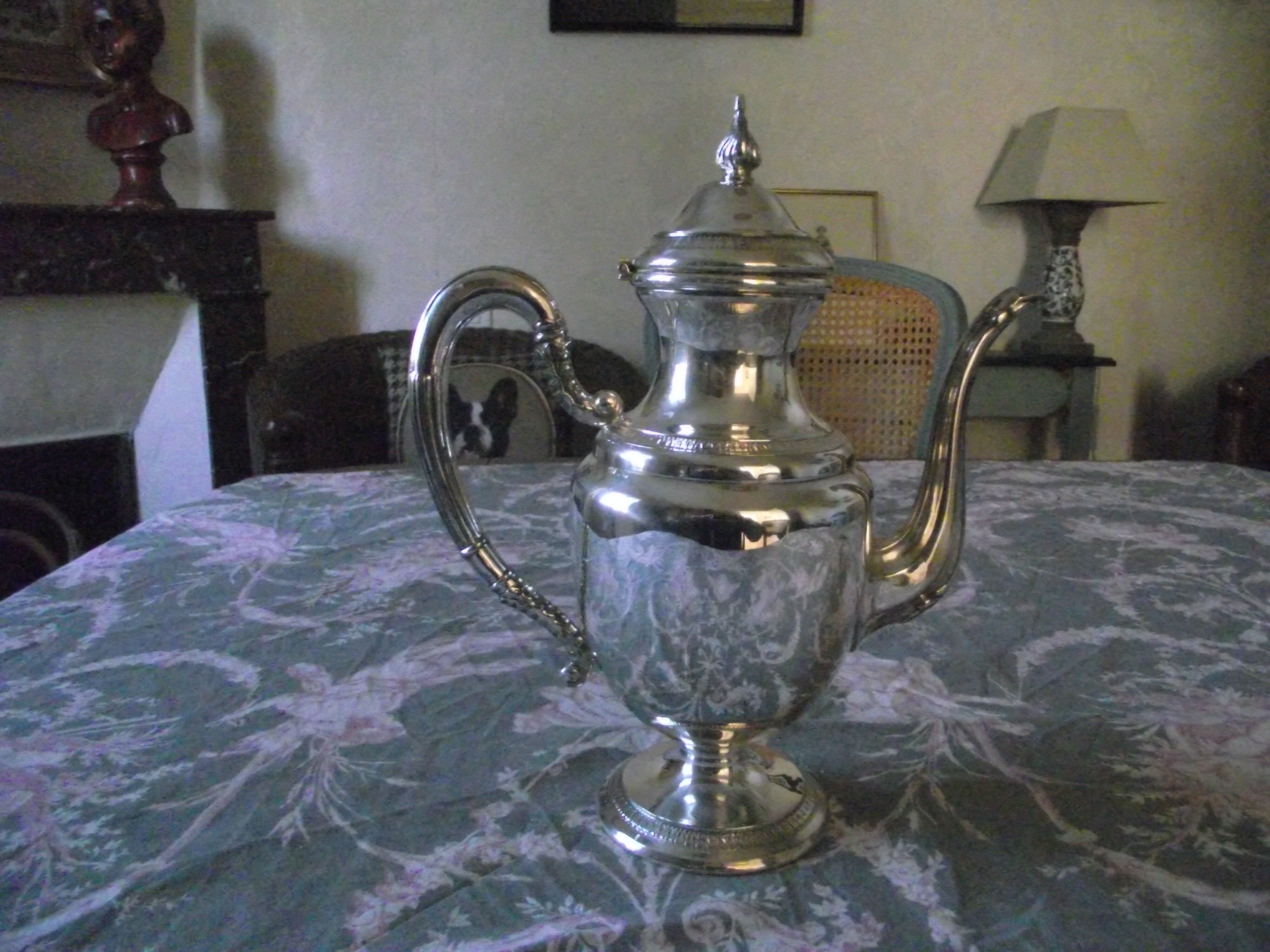 Empire-style silver metal teapot.