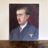 Old oil painting on cardboard portrait of a man in a blue suit